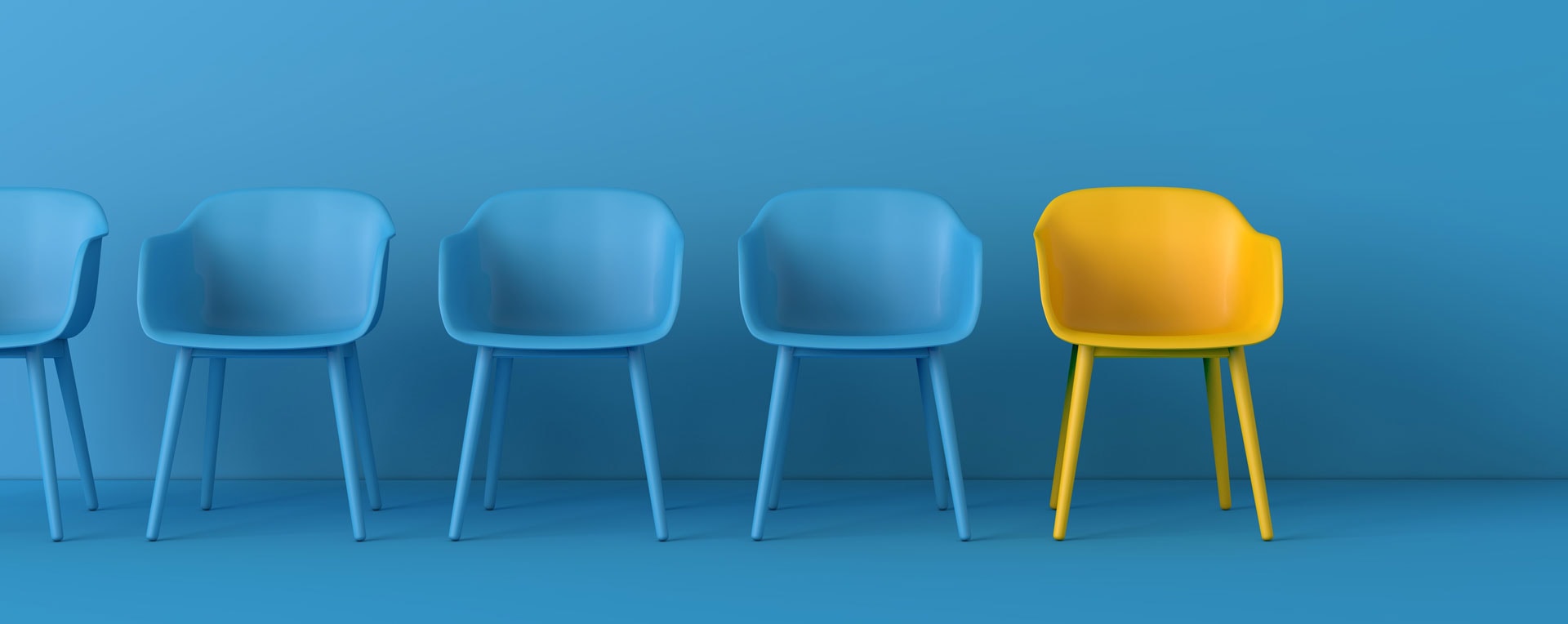 Blaue Stühle und ein gelber Stuhl